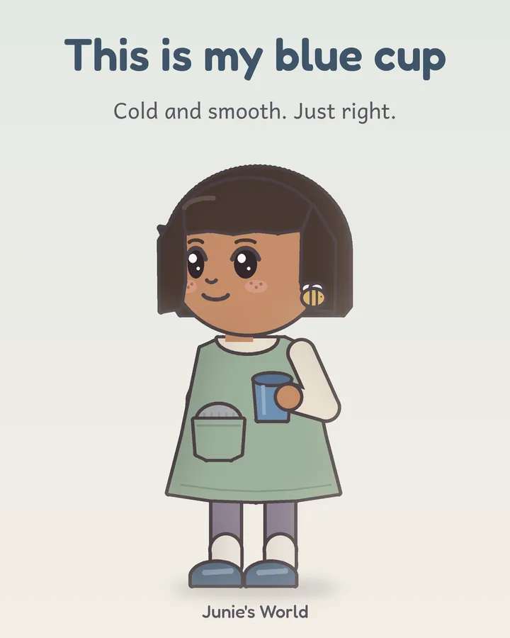 Junie holds her plain blue cup. Her gray ear hat peeks out of her dress pocket.